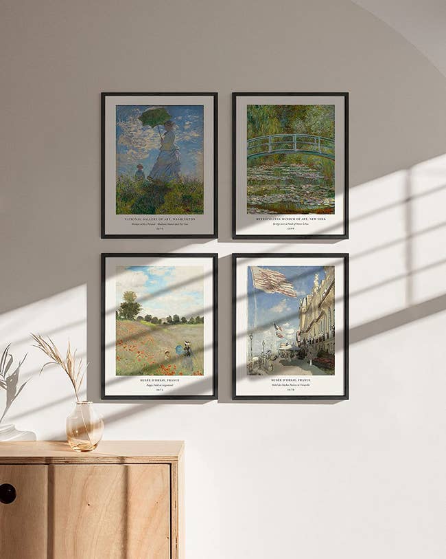 a set of four posters depicting monet art framed on a white wall