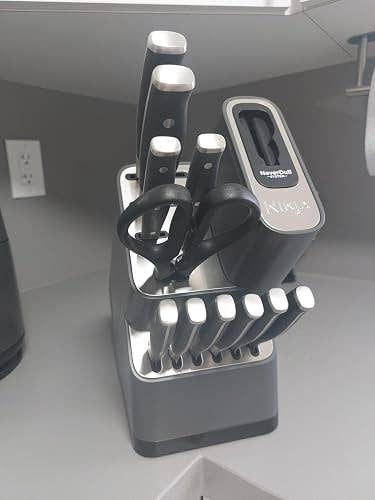 Knife block set with kitchen knives and scissors, neatly arranged on a countertop for home use