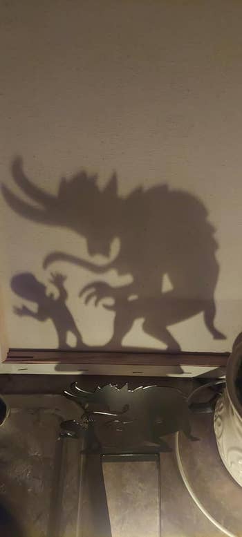 A shadow art scene shows a monster and a small figure