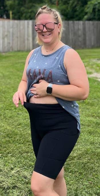 Person outdoors smiling and wearing casual activewear, including a sleeveless top and shorts