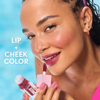 Close-up of a person applying lip and cheek color, smiling. Text reads