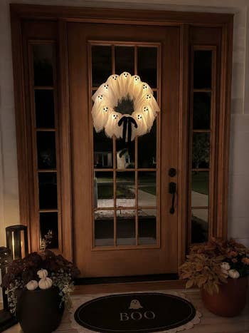 Front door with light-up ghost wreath, lantern, and 