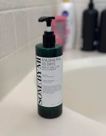 Bottle of Some By Mi AHA BHA PHA 30 Days Miracle Acne Clear Body Cleanser on a bathroom sink
