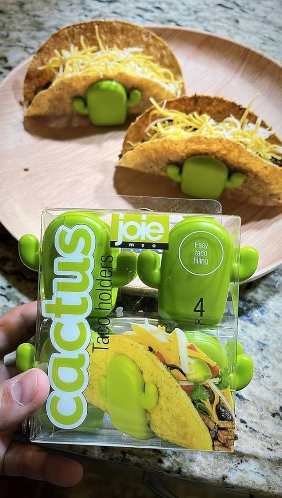 A person holding a package of cactus taco holders