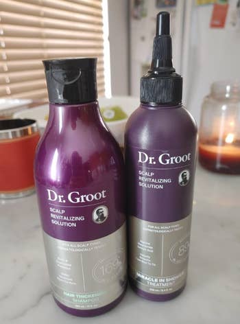 Two bottles of Dr. Groot Scalp Revitalizing Solution on a table, designed for hair thickening and scalp treatment