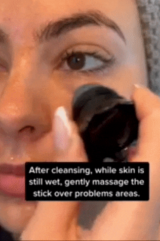 TikToker using the scrubber on their nose and cheeks 