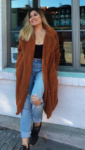 reviewer wearing the coat in caramel