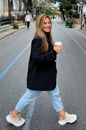 Same reviewer wearing the black blazer