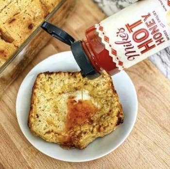Reviewer drizzling it on cornbread