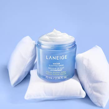 Laneige Water Sleeping Mask jar on small white pillows, highlighting hydration benefits for skin
