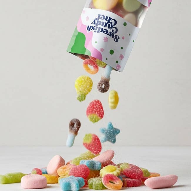Assorted gummy candies spill from a Sweet Candy Club package onto a surface