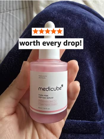 Person holding Medicube PDRN Pink Peptide Serum bottle, labeled 